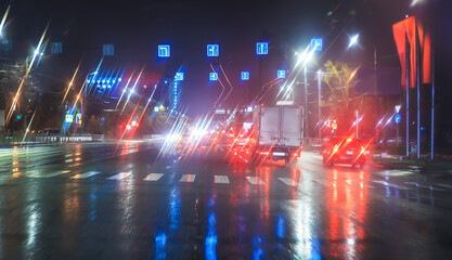 Wall Mural - car traffic at night in the rain on a city