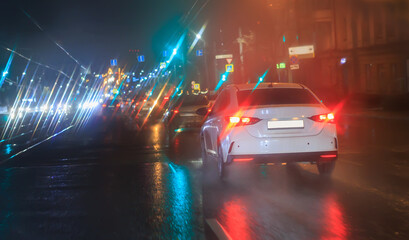 Wall Mural - car traffic at night in the rain on a city
