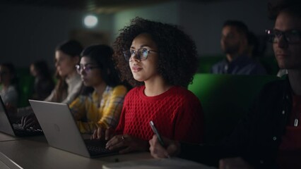 Fototapete - Beautiful Multiethnic African Female Student Studying in University with Diverse Classmates. Young Black Woman Using a Laptop Computer. Applying Her Knowledge to Acquire Academic Skills in Class