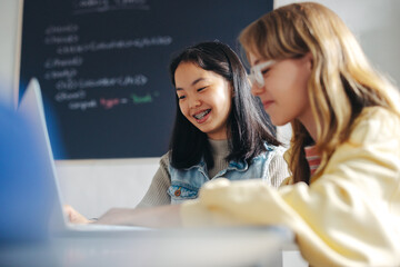 digital literacy for the girl child: kids engaging with each other in a primary school coding class