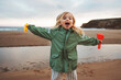 © EVERST - Child playing outdoor family lifestyle vacations girl happy smiling walking with toys on the beach