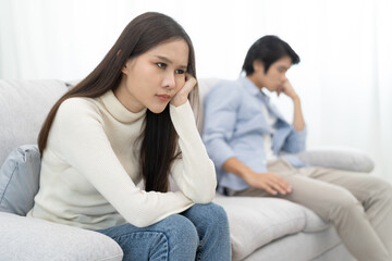 Wall Mural - Family problems, Asian women cover her face and sit separately from husband feel disappointed after quarrels at home.