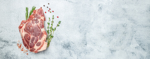 Wall Mural - raw pork steaks on a cutting board with spices on a light background. Long banner format. top view