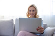 © zinkevych - Smiling woman posing for the camera with her portable computer