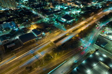 Poster - Aerial view of american freeway intersection at night with fast driving cars and trucks in Tampa, Florida. View from above of USA transportation infrastructure