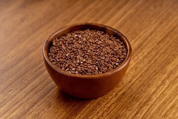 Wall Mural - Chocolate gourmet sprinkles. 45 degree studio shoot isolated on wooden background.