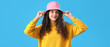 © Pixel-Shot - Teenage girl in pink bucket hat on blue background