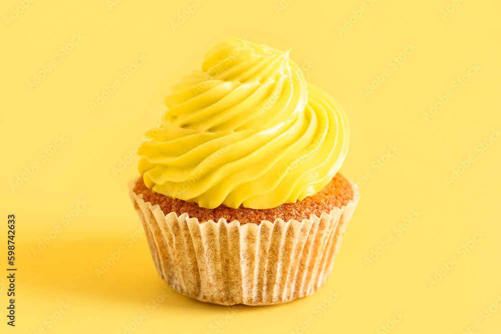 Tasty cupcake on yellow background