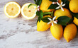 ripe lemons and flowers on table