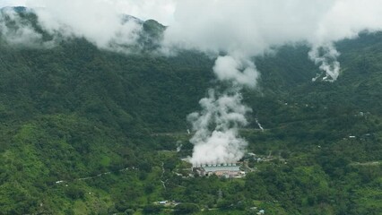 Wall Mural - Aerial drone of geothermal power plant with smoking pipes and steam. Renewable energy production at a power station. Negros, Philippines. Generative AI