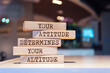 © Uuganbayar - Wooden blocks with words 'Your attitude determines your altitude'.
