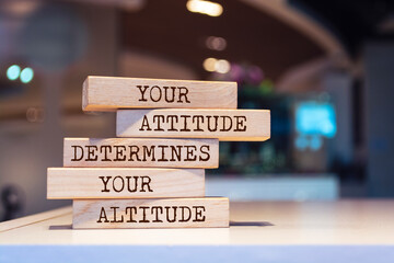 Poster - Wooden blocks with words 'Your attitude determines your altitude'.