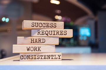 Wall Mural - Wooden blocks with words 'Success requires hard work consistently'.