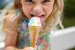© Irina Schmidt - Happy preschool girl eating colorful ice cream in waffle cone on sunny summer day. Little toddler child eat icecream dessert. Sweet food on hot warm summertime days. Bright light, colorful ice-cream