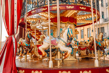 Old Carousel In The Park. Three Horses And A Plane On A Traditional Fair Carousel. Carousel With Horses In Barcelona, ​​Spain