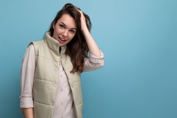 Sticker - portrait of charming dreamy woman with dark hair posing on blue background with copy space