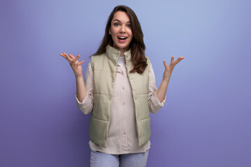 Canvas Print - caucasian young brunette woman with hair below her shoulders smiles and poses against the background with copy space