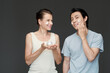 © DragonImages - Happy man and woman applying rich nourishing cream on face