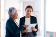 © Tinashe N/peopleimages.com - Its the tool of choice for every go getter. two businesswomen working together on a digital tablet in an office.