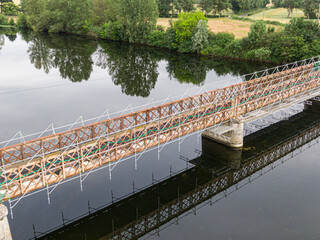 Scaffolding used for maintenance or restoration work on a small bridge over a large river the Cher