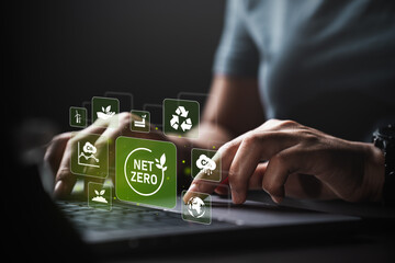 Young woman using laptop with net zero 2050 carbon neutral environment icon. Long-term, climate-neutral strategy greenhouse gas emissions target