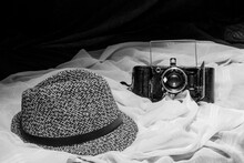 A Simple Black And White Still Life With A Jean Hat And A Vintage Photo Camera