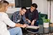 © PintoArt - gay couple in real estate signing the purchase of their new house