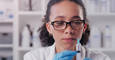 Wall Mural - lets get testing something new. a young scientist using a syringe in a lab.