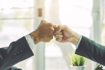 two businessman doing fist bump as business partners.
