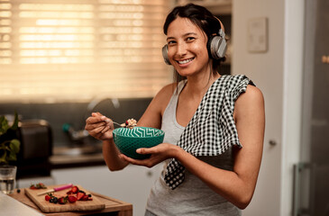 Sticker - Join me for a healthy breakfast. a young woman making a healthy snack with strawberries at home.