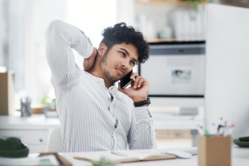 Wall Mural - Im sorry, thats my mistake. a young businessman looking stressed out while talking on a cellphone in an office.