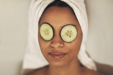 Canvas Print - Feel the magic of relaxation and self-awareness overwhelming you. a woman relaxing in a spa with cucumber slices on her eyes.