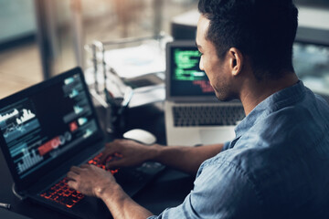 Fototapete - Lost my way for a minute, back on track. a young man using a laptop in a modern office.