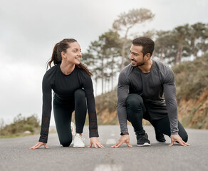 Poster - Lets race. Full length shot of two young athletes crouched down in a starters position before exercising outside.