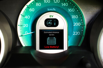 Wall Mural - Low battery warning light on black screen instrument panel of EV electric vehicle, Electric car technology concept.