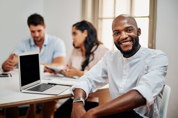 Poster - Leave the task up to us. Portrait of a young businessman having a meeting with colleagues in a modern office.