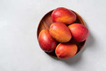 Wall Mural - Mango background design concept. Top view Diced fresh mango fruit on gray table.