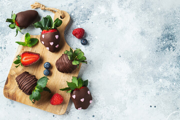 Gourmet chocolate covered strawberries on the light background. Top view with copy space