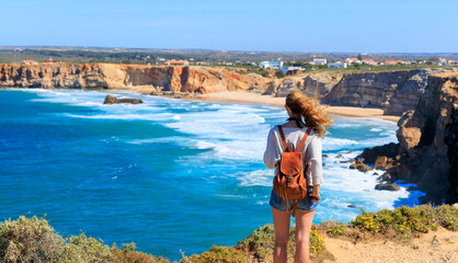 Wall Mural - Woman tourist contempling atlantic ocean in Portugal