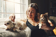 © Chanelle Malambo/peopleimages.com - Relaxing days indoors with my home dogs. a young woman relaxing with her dogs on the sofa at home.
