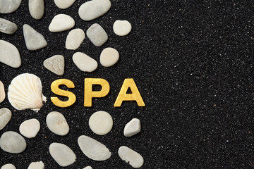 Wall Mural - spa word in black sand with pebbles