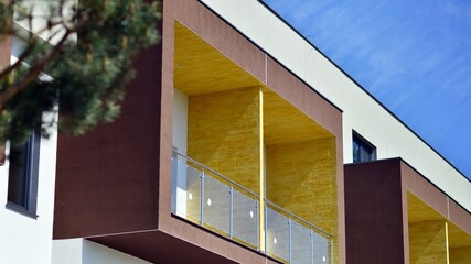 Modern apartment buildings on a sunny day with a blue sky. Facade of a modern apartment building. Contemporary residential building exterior in the daylight. 