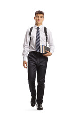 Poster - Full length portrait of a male student carrying books and walking towards camera