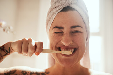 Wall Mural - Keep brushing, keep smiling. an attractive young woman brushing her teeth in the bathroom at home.