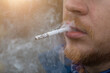 Close up portrait of young man smoking cigarette