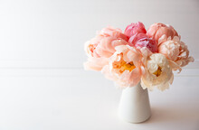 Beautiful Bouquet Of Fresh Coral Peony Flowers In Full Bloom In Vase. Floral Still Life With Blooming Peonies. Negative Space For Text.