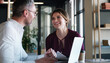 © Grady Reese/peopleimages.com - Their ambition says it all. a businessman and businesswoman using a laptop and having a discussion in a modern office.