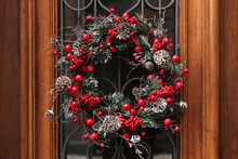 Beautiful Christmas Wreath Hanging On Wooden Door
