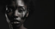 African american woman with her face painted like she's from an African tribe on dark background. Generative AI.