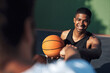 © N F/peopleimages.com - Thanks for the great game. a sporty young man giving his teammate a fist bump on a basketball court.